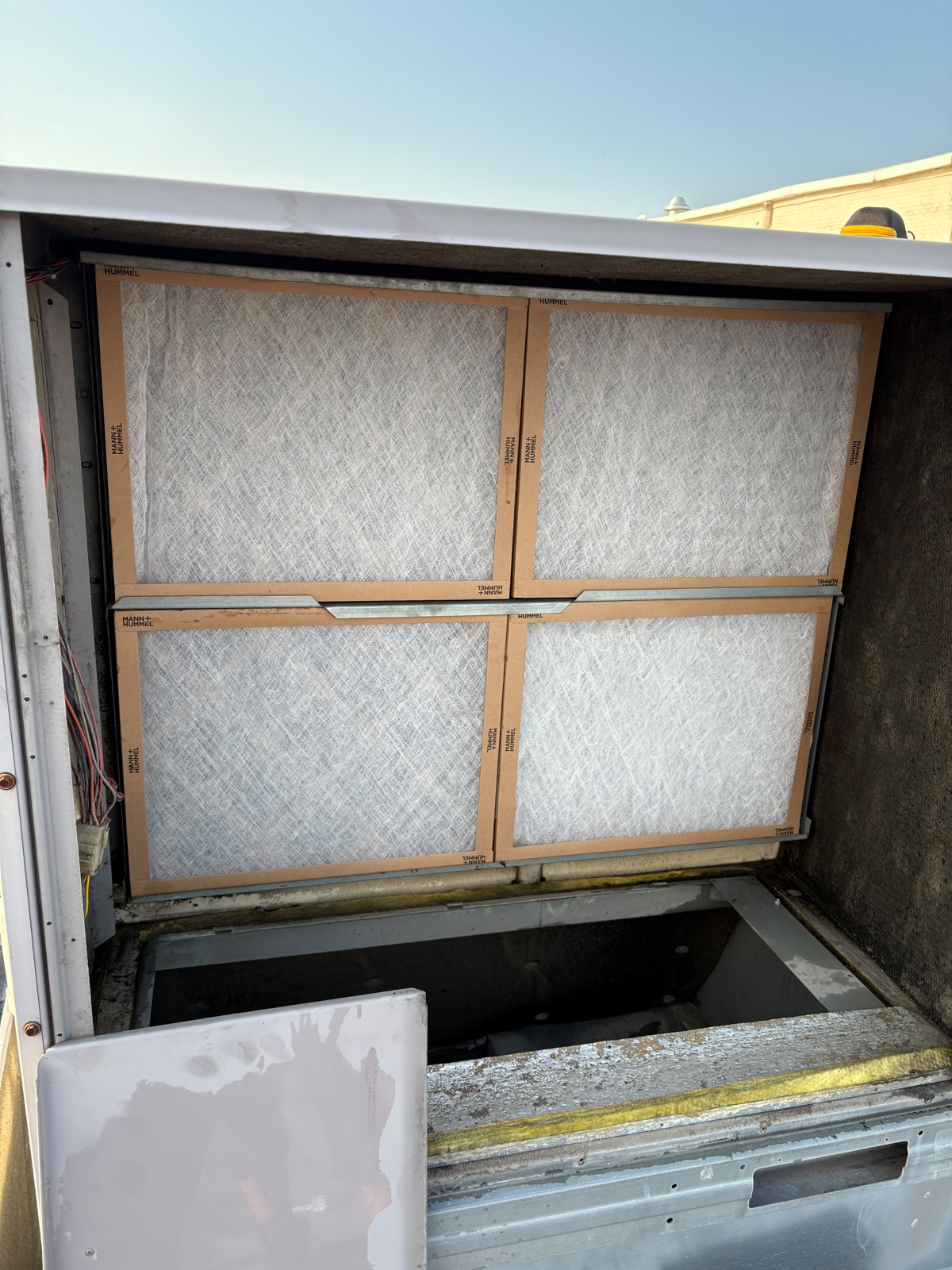 Carrier rooftop HVAC unit with clean air filters in place after service at Fit and Fight Gym