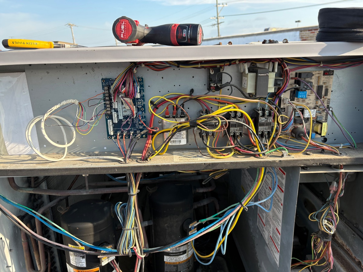 Carrier rooftop HVAC control compartment inspected during diagnosis