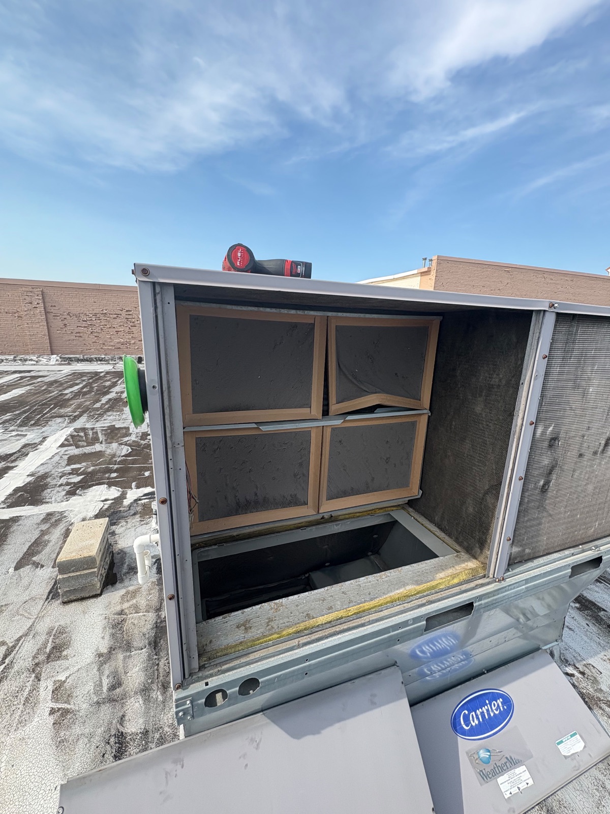 Carrier rooftop HVAC unit opened for inspection at Fit and Fight Gym in Niles